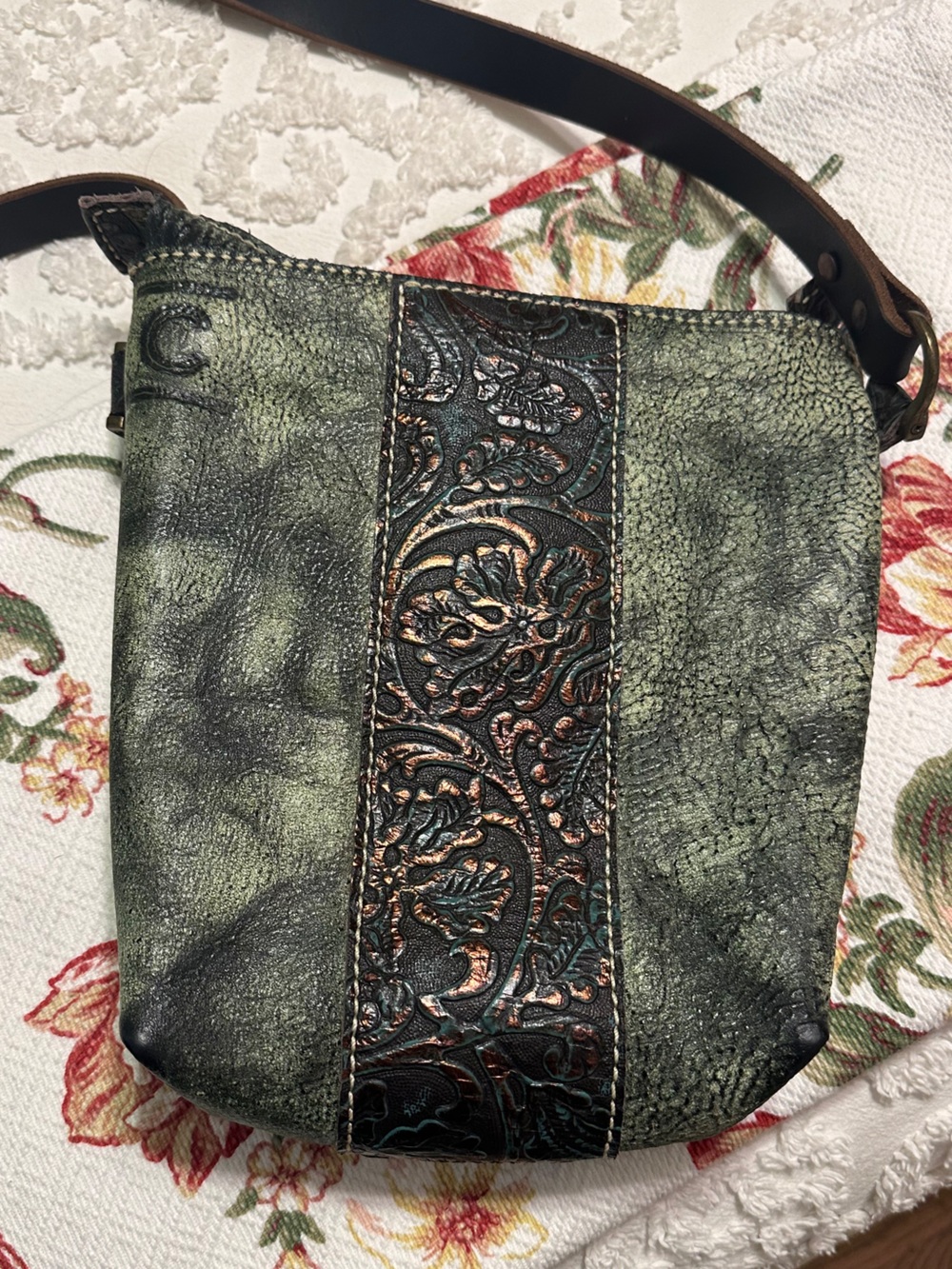 Crossbody Leather handbag featuring weathered green texture.